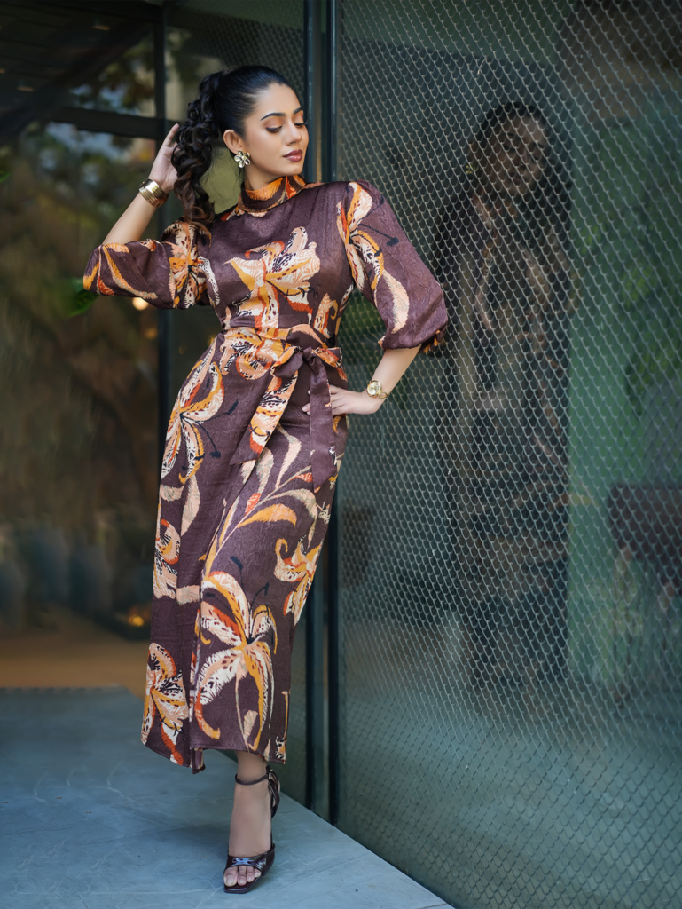 Model wearing ARIZA Plum Floral Belted Long Tunic with mustard and cream botanical motifs, balloon sleeves and a matching waist tie.